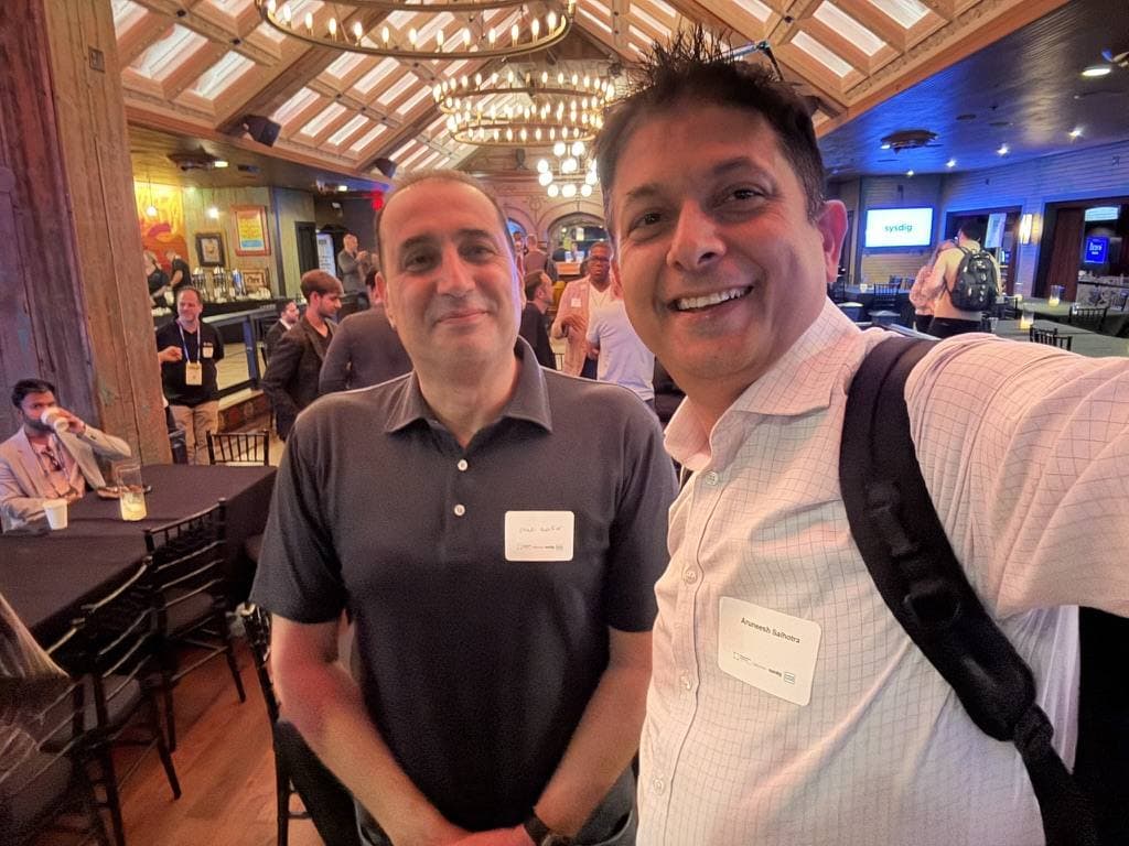 Aruneesh Salhotra with a colleague at an evening event on the conference circuit