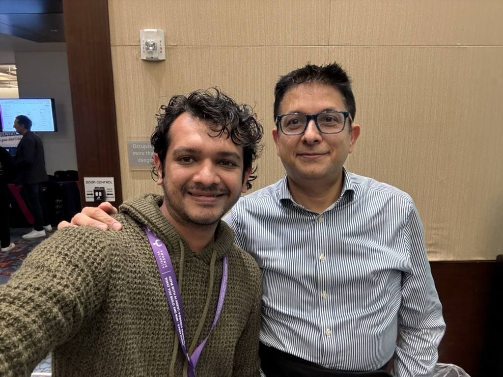 Aruneesh Salhotra with a colleague at a conference