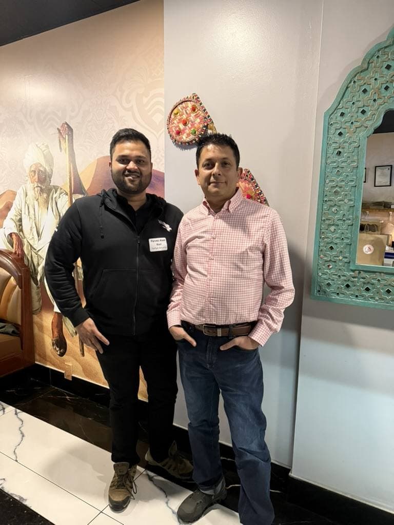Aruneesh Salhotra with a colleague at a restaurant on the conference circuit