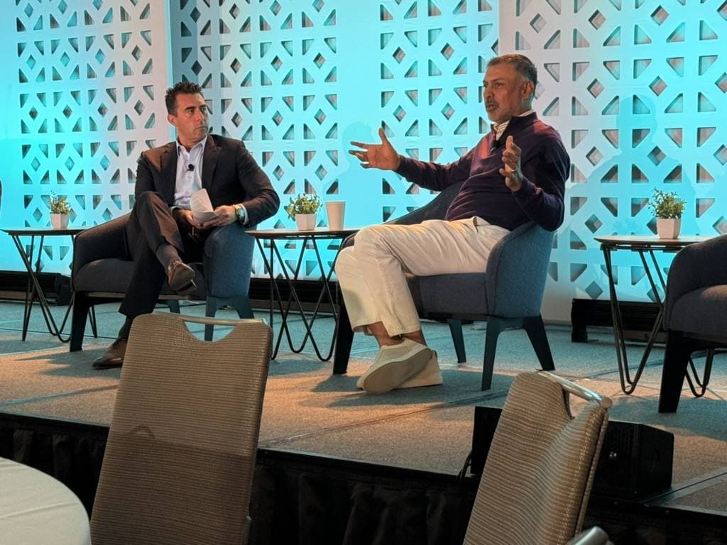 A fireside chat on stage at a conference Aruneesh Salhotra attended