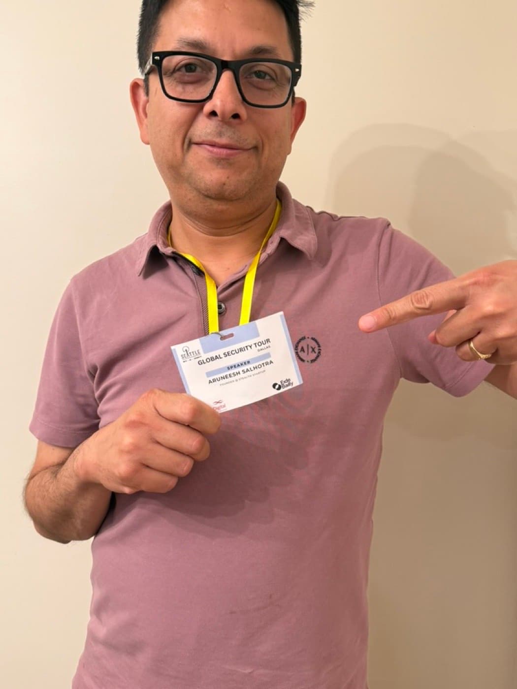 Aruneesh Salhotra holding his Global Security Tour Dallas speaker badge