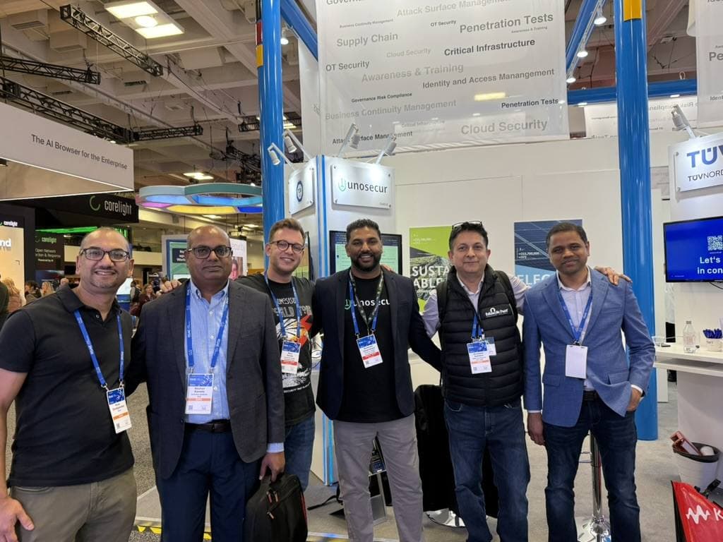Aruneesh Salhotra with a group at a vendor booth on the RSAC 2026 expo floor