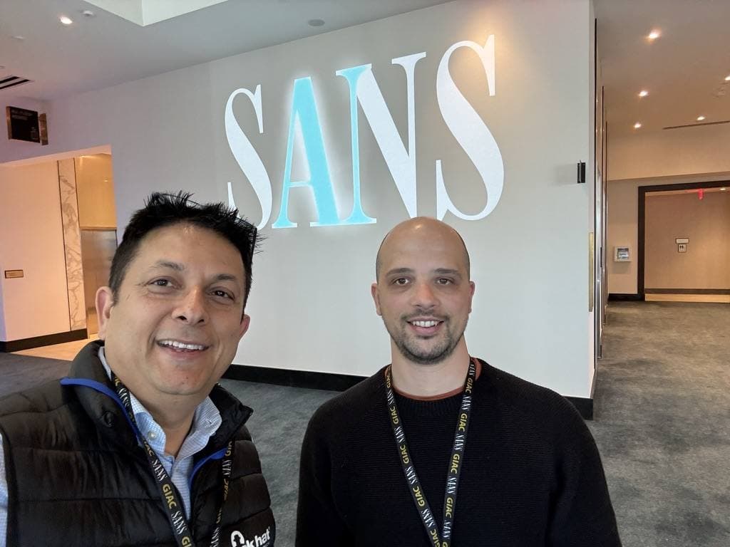 Aruneesh Salhotra with a colleague by the SANS Institute sign