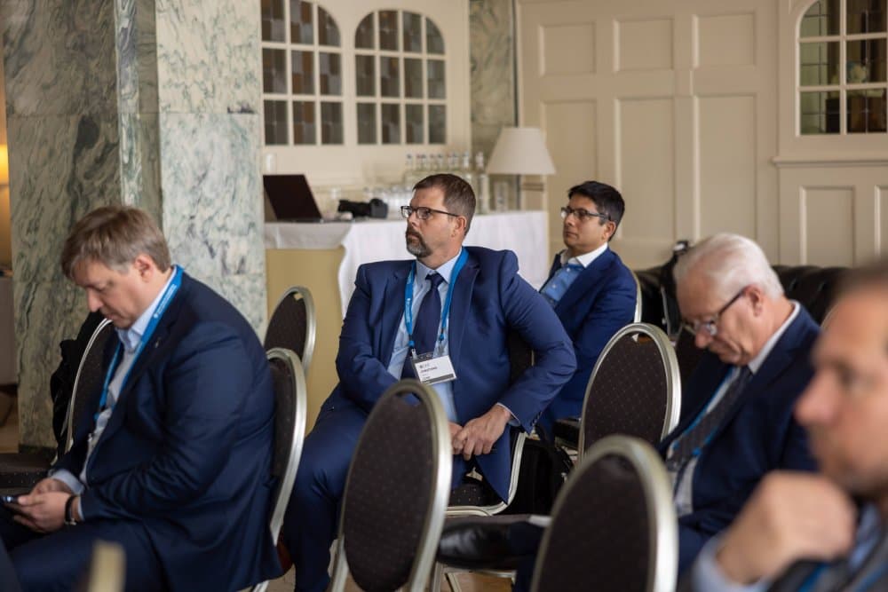 Aruneesh Salhotra seated in a panel audience in Davos